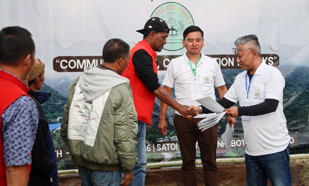 Aochuba IFS, Conservator of Forests (Northern Territorial Circle) distributing ComSR Charter copies to the Village representatives of Satoi Town and 10 Villages under Satoi Range during the Satoi Connect fest held from March 26 - 28. (Photo Courtesy: Obed Bohovi Swu)